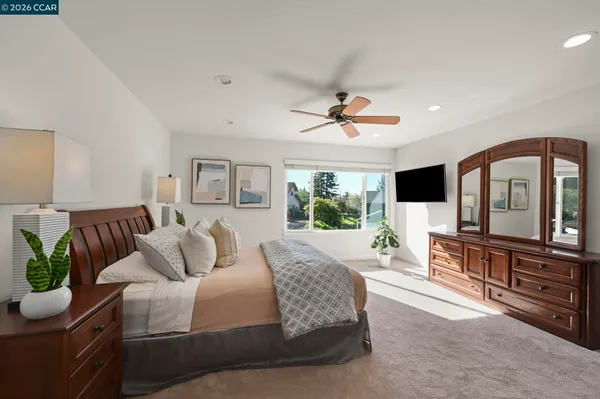 a bathroom with a granite countertop sink a large mirror and a wooden cabinets