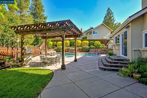 a view of a house with swimming pool and sitting area
