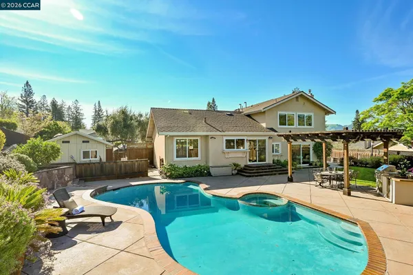 a view of a house with swimming pool and sitting area