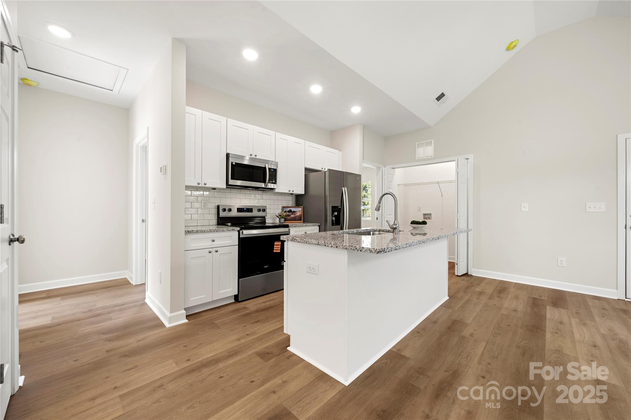 1104 Silver Street Shelby, NC 28152 - Photo 13 of 28 a kitchen with a sink a microwave a refrigerator and cabinets