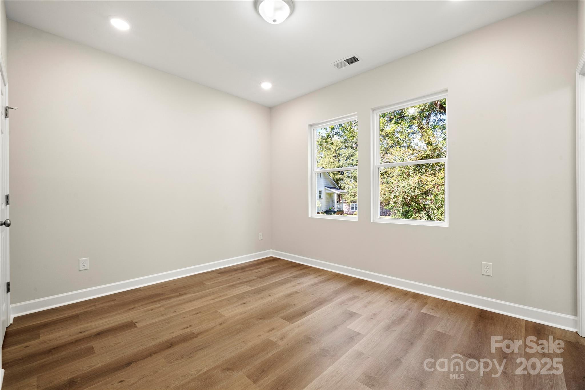 1104 Silver Street Shelby, NC 28152 - Photo 19 of 28 an empty room with wooden floor and windows