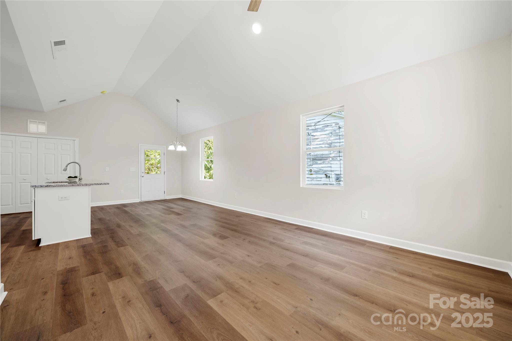 1104 Silver Street Shelby, NC 28152 - Photo 6 of 28 an empty room with wooden floor and windows