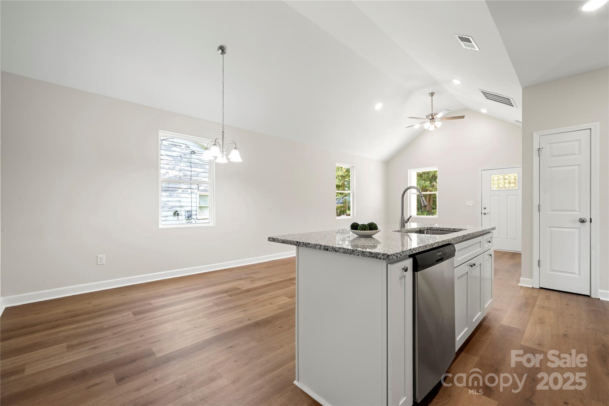 1104 Silver Street Shelby, NC 28152 - Photo 9 of 28 a kitchen with stainless steel appliances granite countertop a stove and a wooden floors