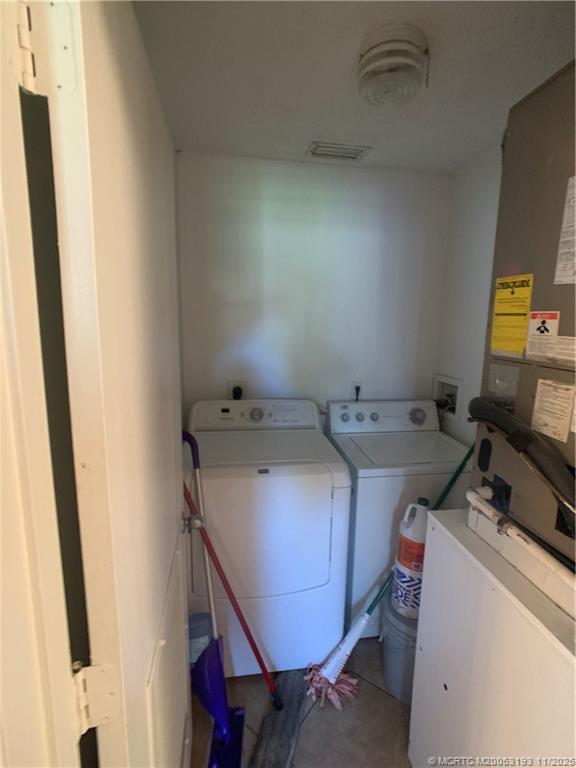 6105 Southwest Gator Trail, Unit A Palm City, FL 34990 - Photo 11 of 19 a utility room with dryer and washer