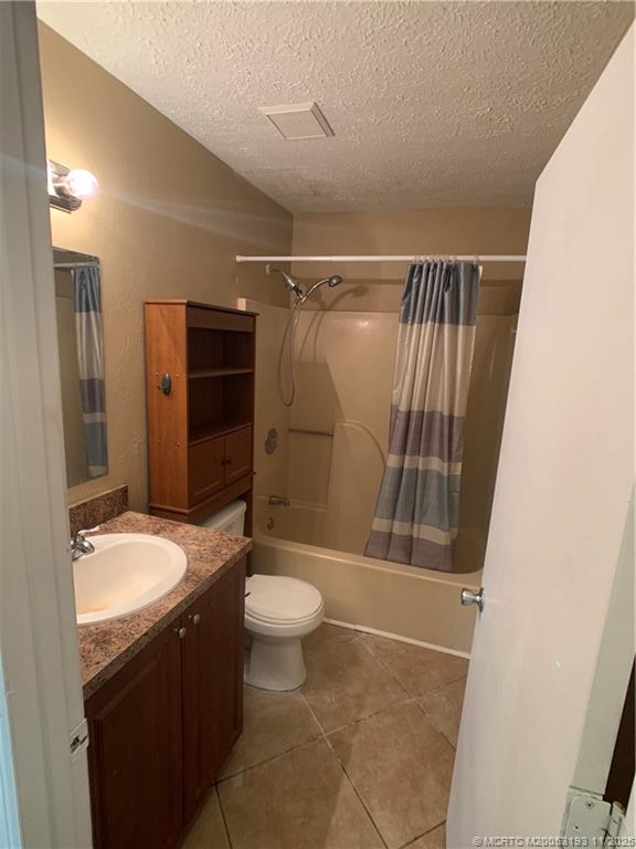 6105 Southwest Gator Trail, Unit A Palm City, FL 34990 - Photo 12 of 19 a bathroom with a granite countertop sink toilet and shower