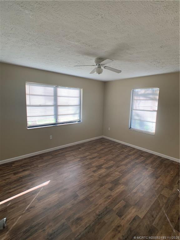 6105 Southwest Gator Trail, Unit A Palm City, FL 34990 - Photo 13 of 19 a view of an empty room with wooden floor and a window
