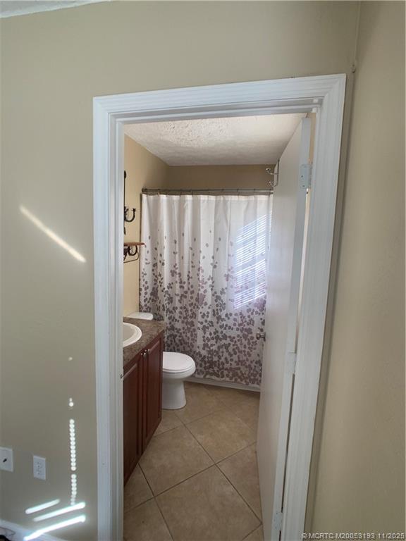 6105 Southwest Gator Trail, Unit A Palm City, FL 34990 - Photo 14 of 19 a bathroom with a toilet and a shower