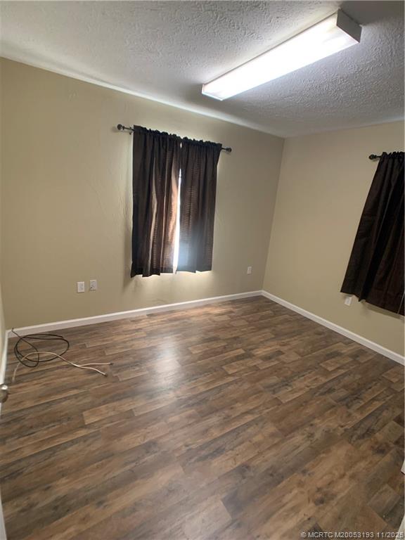 6105 Southwest Gator Trail, Unit A Palm City, FL 34990 - Photo 16 of 19 a view of an empty room with wooden floor