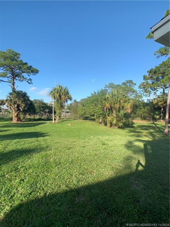 6105 Southwest Gator Trail, Unit A Palm City, FL 34990 - Photo 19 of 19 a view of a grassy field with trees