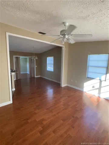 a view of a kitchen with a sink and a chandelier fan