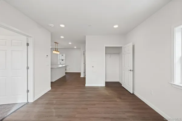 a view of a hallway with wooden floor