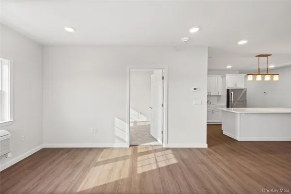 a view of a kitchen with wooden floor