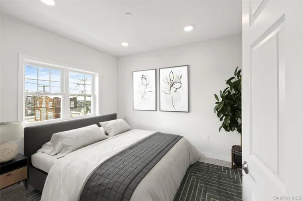 a bedroom with a large bed and a window