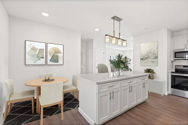 a kitchen that has a table and chairs in it