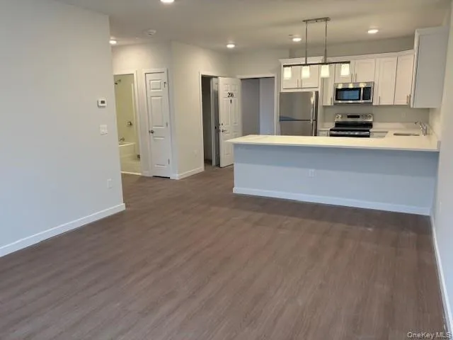 a view of kitchen with wooden floor