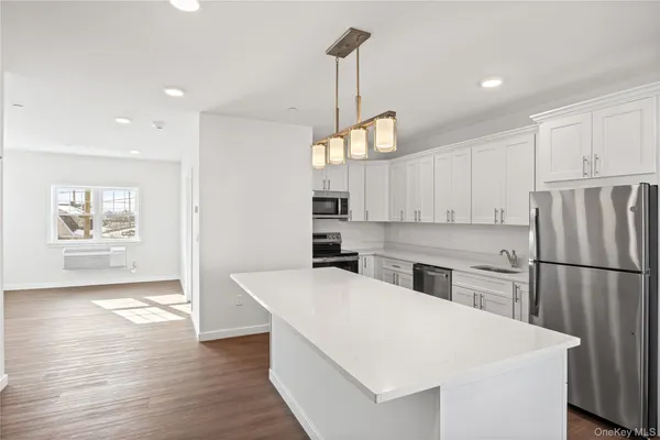a kitchen with refrigerator cabinets and wooden floor