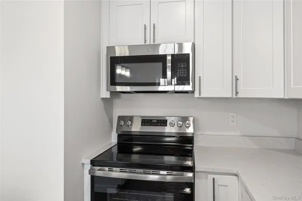 a stove top oven sitting inside of a kitchen