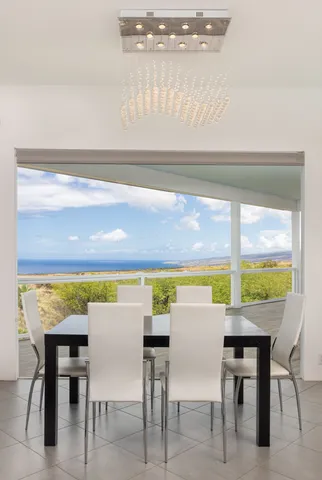 a view of a dining room with furniture and a window