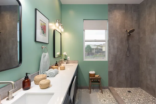 a bathroom with a sink mirror and a window