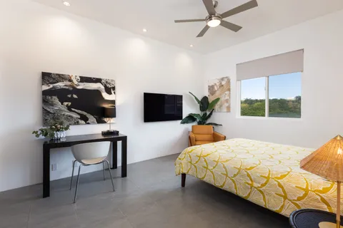a bedroom with furniture and a window