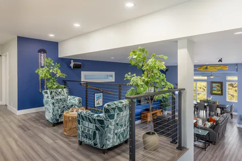 a living room with furniture and flowers