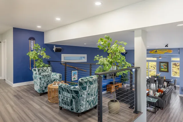 a living room with furniture and flowers