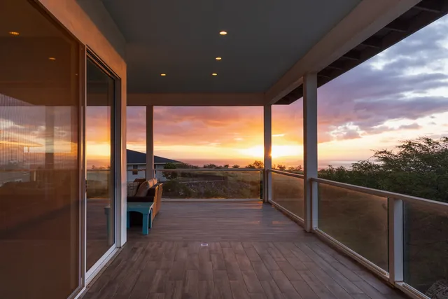 a view of a porch with wooden floor and outdoor seating