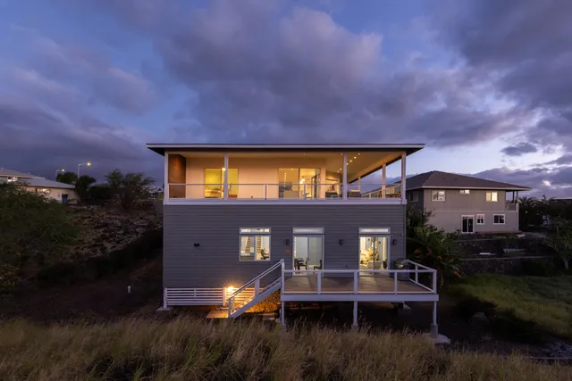 a view of house with yard and lake view