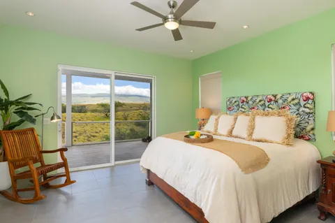 a bedroom with a bed and a view of fan