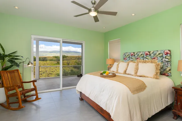 a bedroom with a bed and a view of fan
