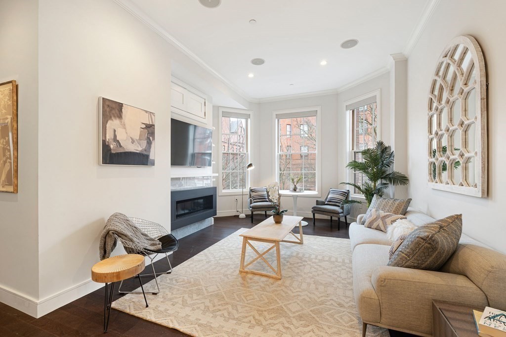 a living room with furniture a fireplace and a flat screen tv
