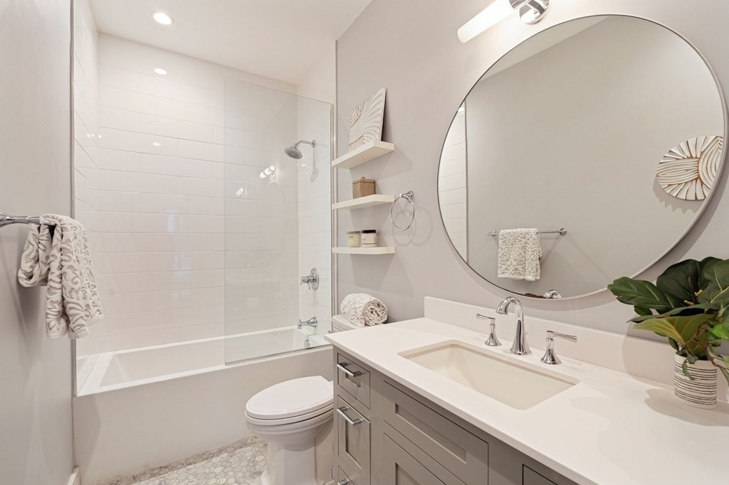 11 Exeter Street, Unit 5 Boston, MA 02116 - Photo 12 of 13 a bathroom with a sink a toilet and a mirror