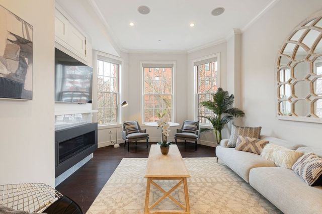 a living room with furniture wooden floor and a fireplace