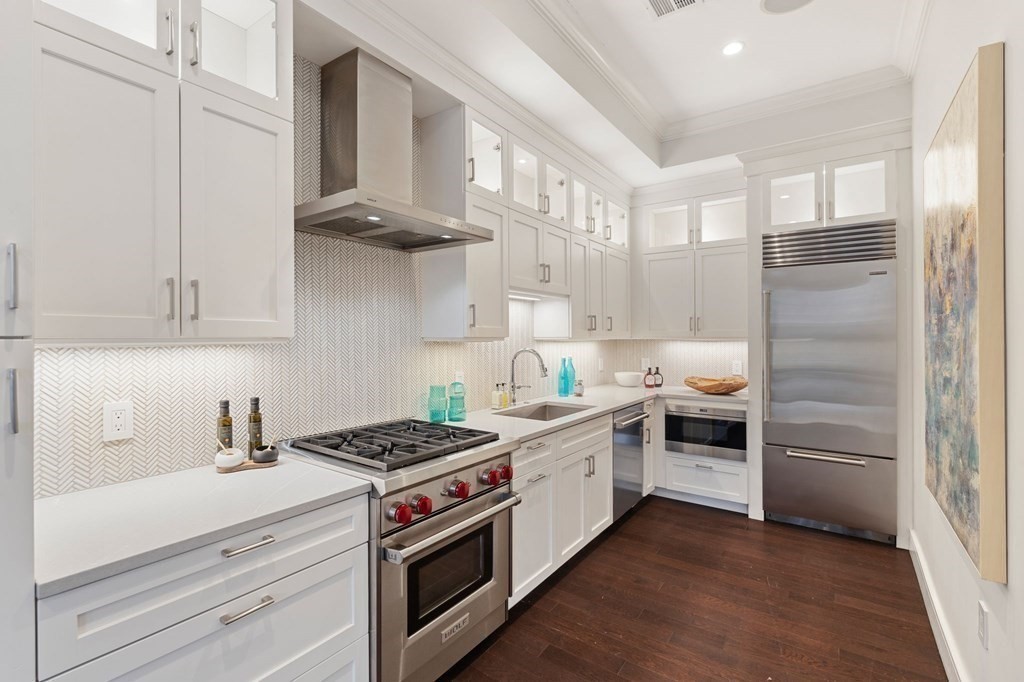 11 Exeter Street, Unit 5 Boston, MA 02116 - Photo 5 of 13 a kitchen with stainless steel appliances granite countertop a stove and a refrigerator