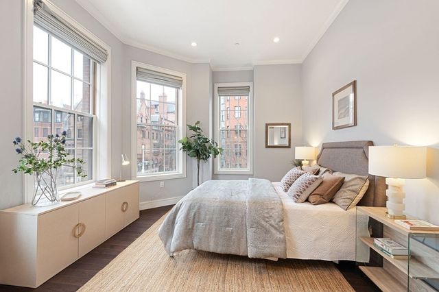 a bedroom with a large bed and a large window