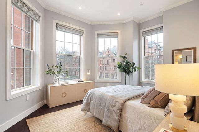 a bedroom with a large bed and a large window