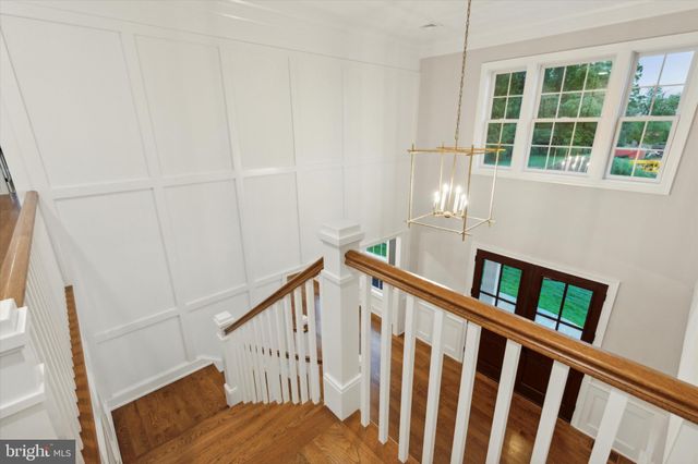 a large kitchen with stainless steel appliances kitchen island a large counter top and a wooden floors