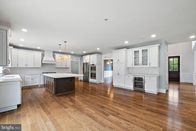 a view of empty room with wooden floor and windows