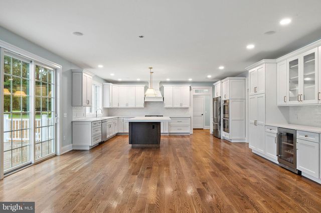 a view of empty room with wooden floor and fireplace