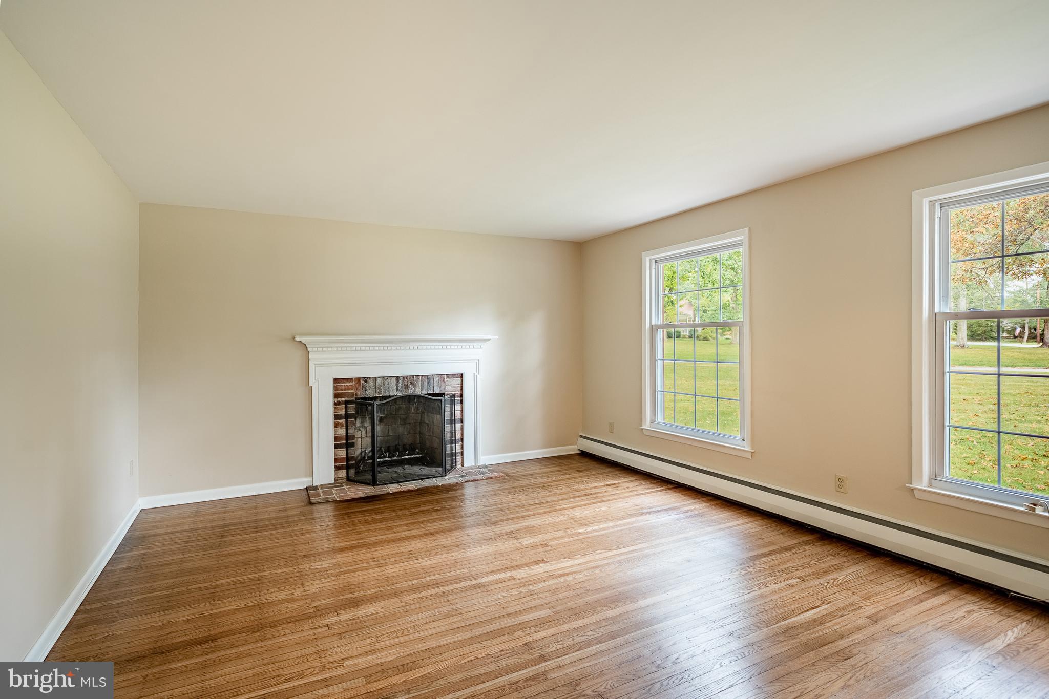 8 Andrews Road Malvern, PA 19355 - Photo 11 of 62 an empty room with wooden floor fireplace and windows