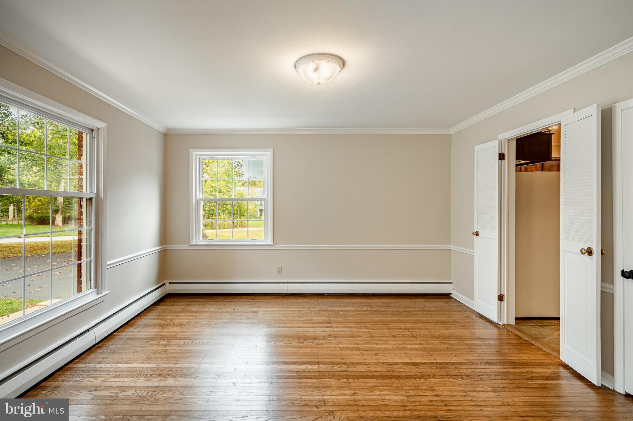 8 Andrews Road Malvern, PA 19355 - Photo 15 of 62 an empty room with wooden floor and windows