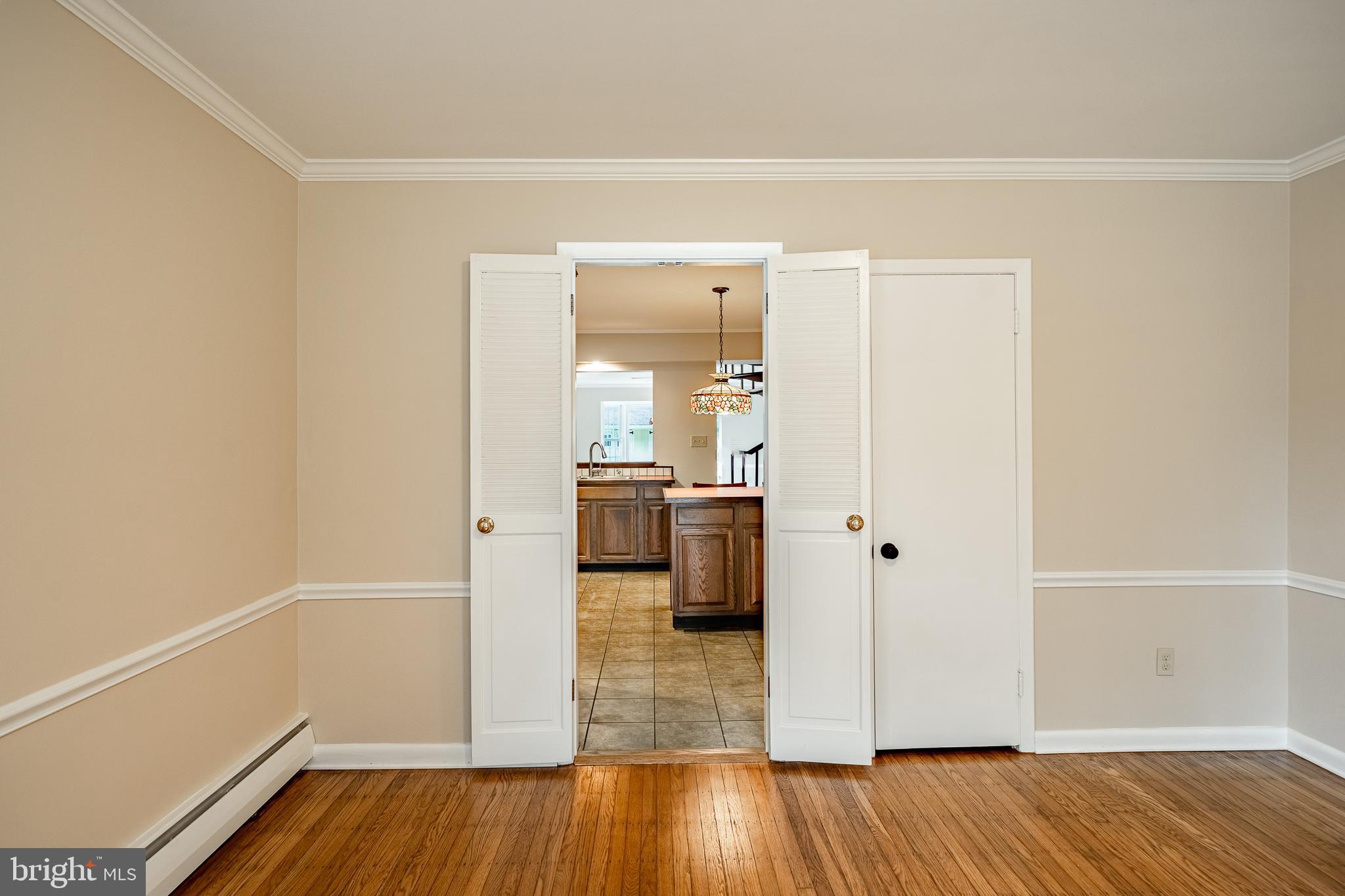 8 Andrews Road Malvern, PA 19355 - Photo 16 of 62 a view of a hallway with wooden floor and a bathroom
