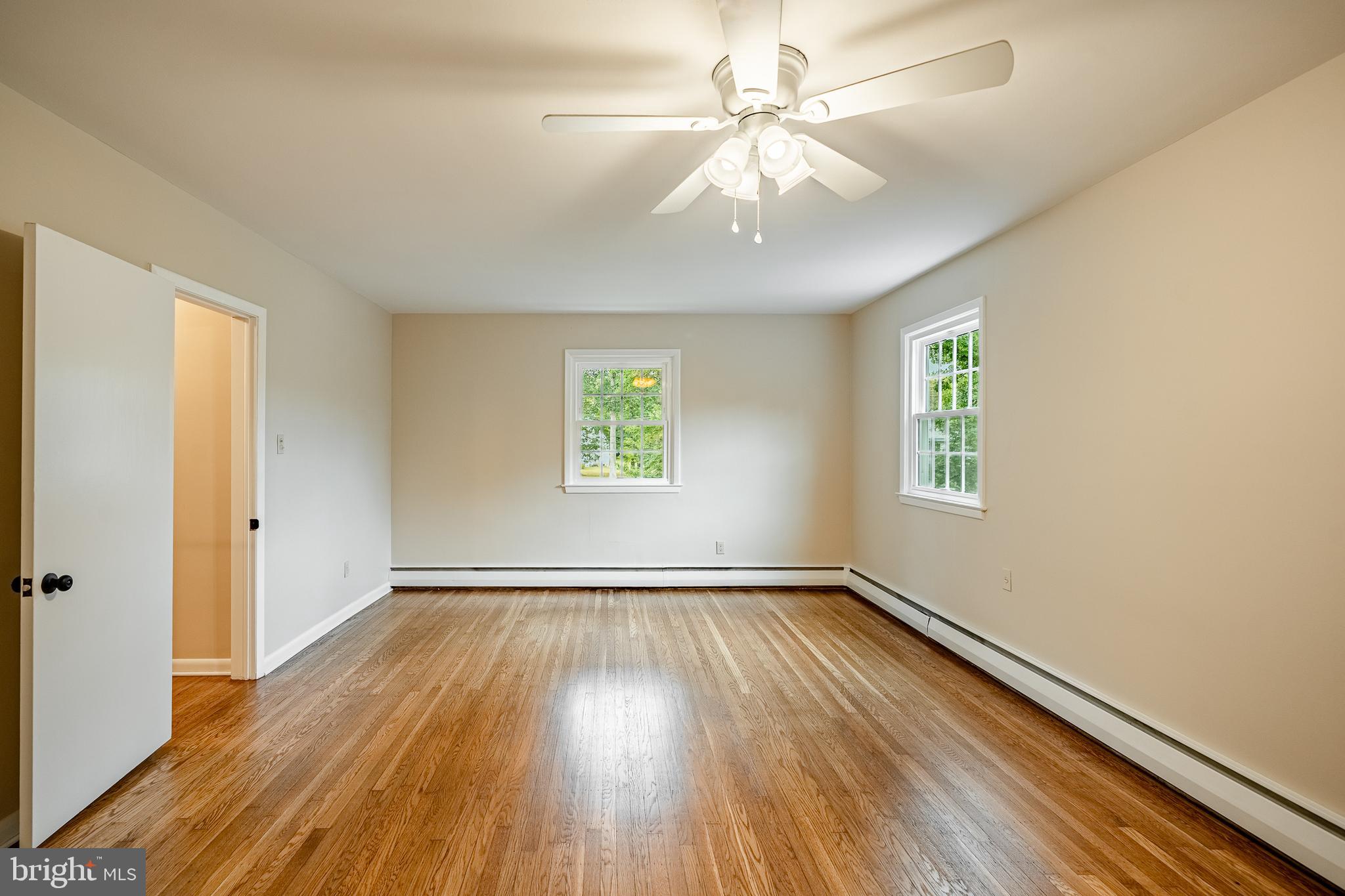 8 Andrews Road Malvern, PA 19355 - Photo 40 of 62 a view of an empty room with wooden floor and a window