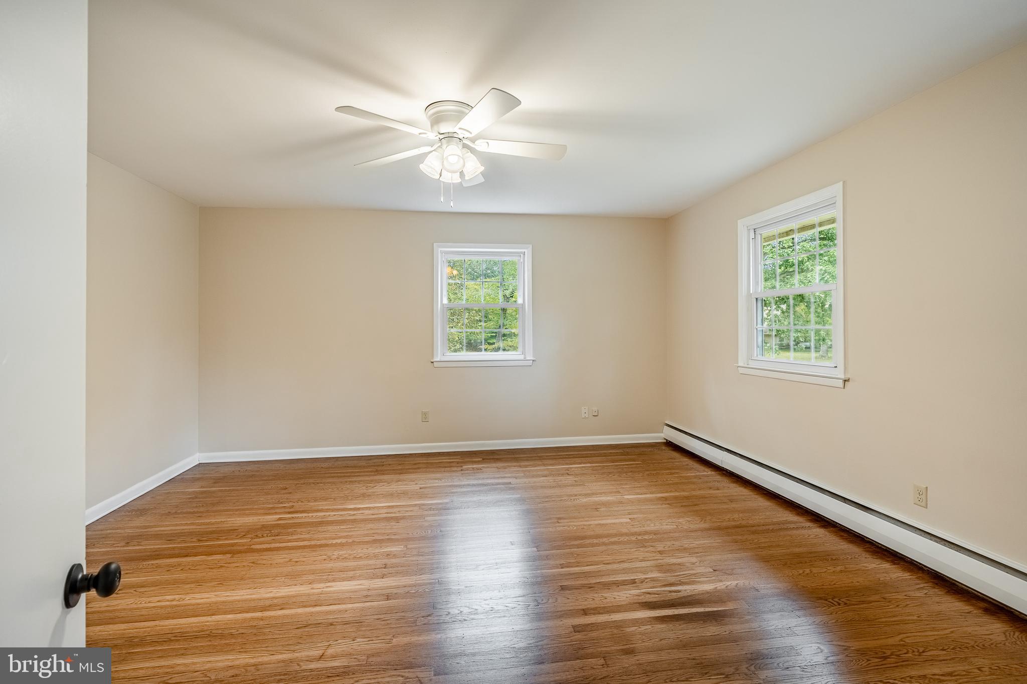 8 Andrews Road Malvern, PA 19355 - Photo 46 of 62 a view of an empty room with wooden floor and a window