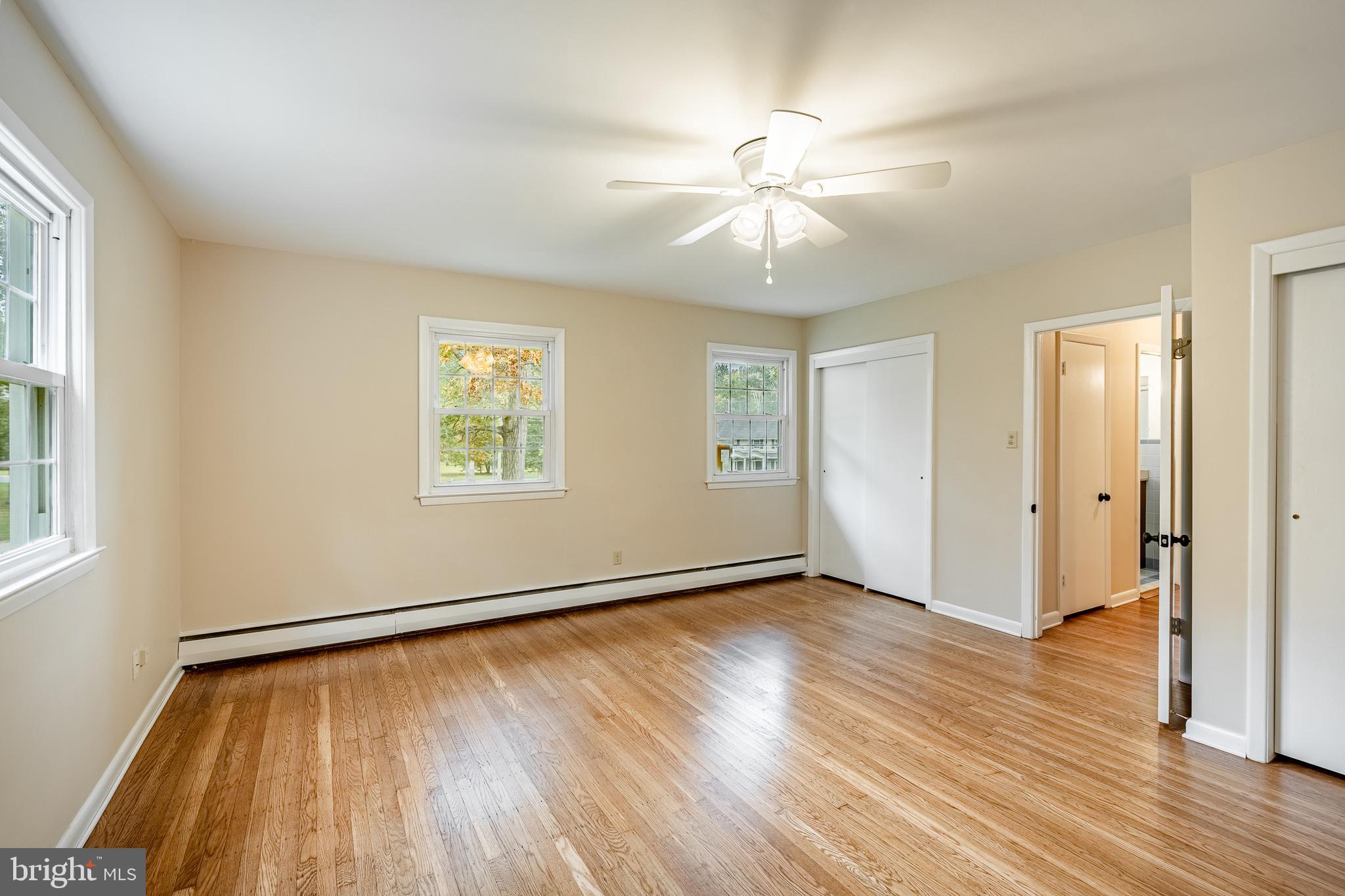 8 Andrews Road Malvern, PA 19355 - Photo 47 of 62 a view of an empty room with wooden floor and a window