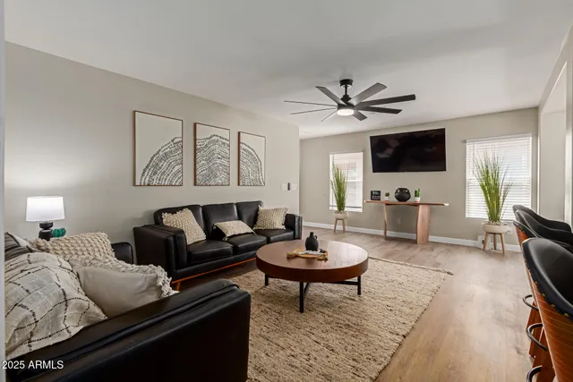 a living room with furniture a rug and a flat screen tv