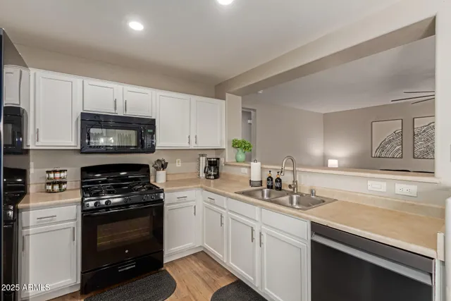 a kitchen with stainless steel appliances granite countertop a refrigerator stove and sink