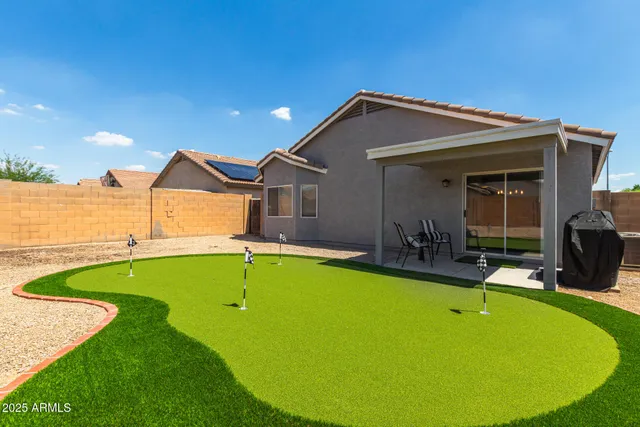 a view of a backyard with furniture