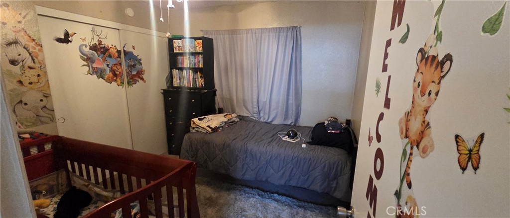 1548 Ranch Road San Bernardino, CA 92407 - Photo 14 of 26 a bed and a table in a bedroom
