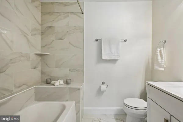 a bathroom with a sink a toilet and vanity